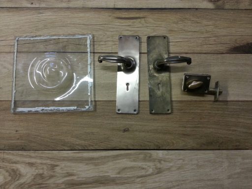 Antique brass door handles, locks and bullseye glass.