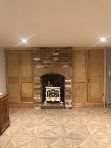 Built-in wardrobes next to log burner